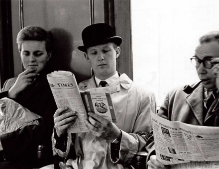 A commuter reads Lady Chatterley’s Lover over their neighbour’s shoulder, London Underground, 1960.