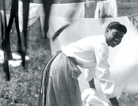 A young woman hanging up laundry, Newport, Rhode Island, 1903.