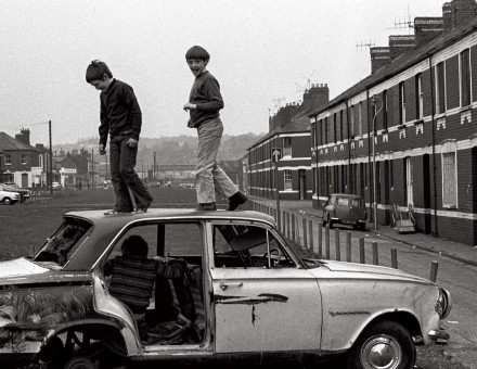 Boys playing on an abandoned car, Newport, 1974. Robin Weaver/Alamy.